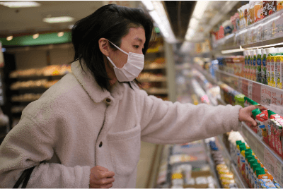 Woman grabbing a juice in a grocery store